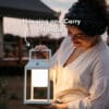 Portable white solar LED lantern on table and wall, warm light glow