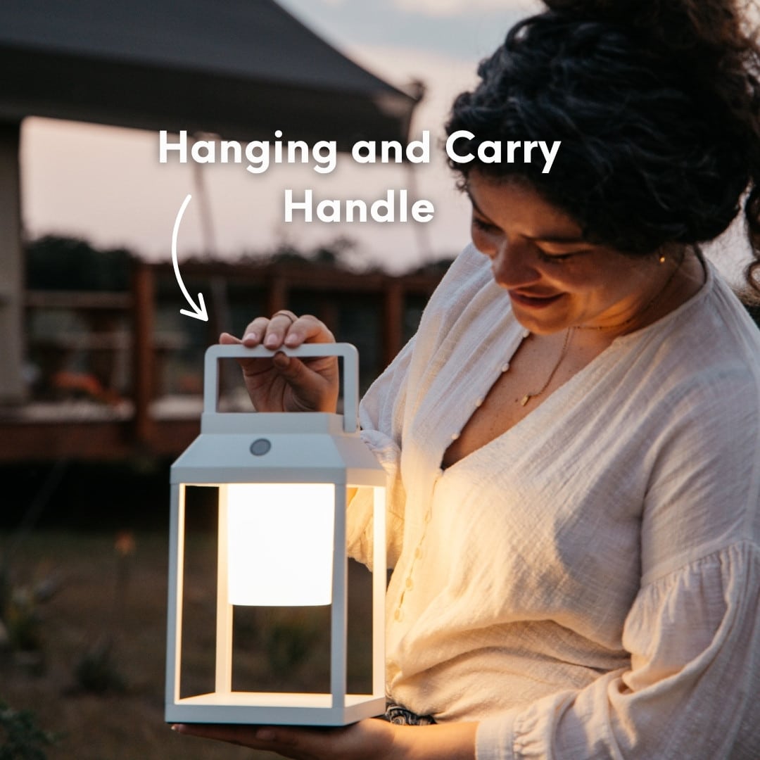 Portable white solar LED lantern on table and wall, warm light glow