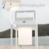 Portable white solar LED lantern on table and wall, warm light glow