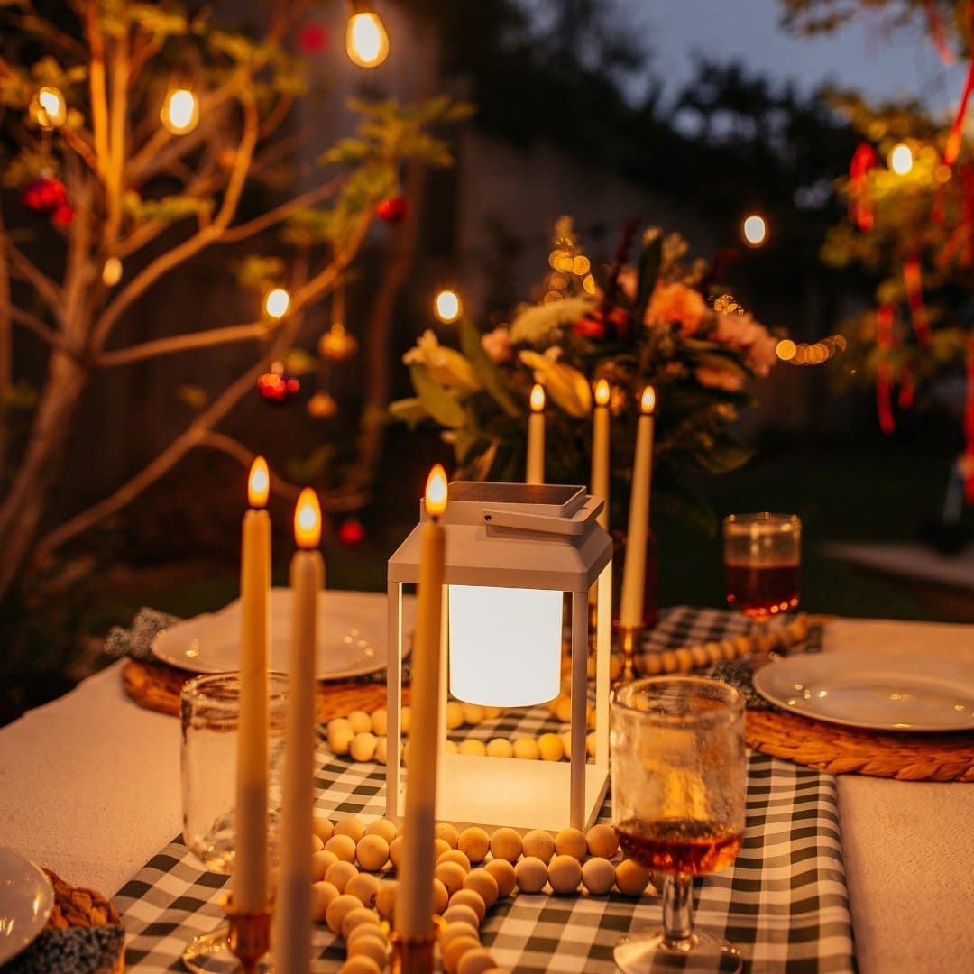 White solar LED lantern mounted on outdoor wall with soft glow