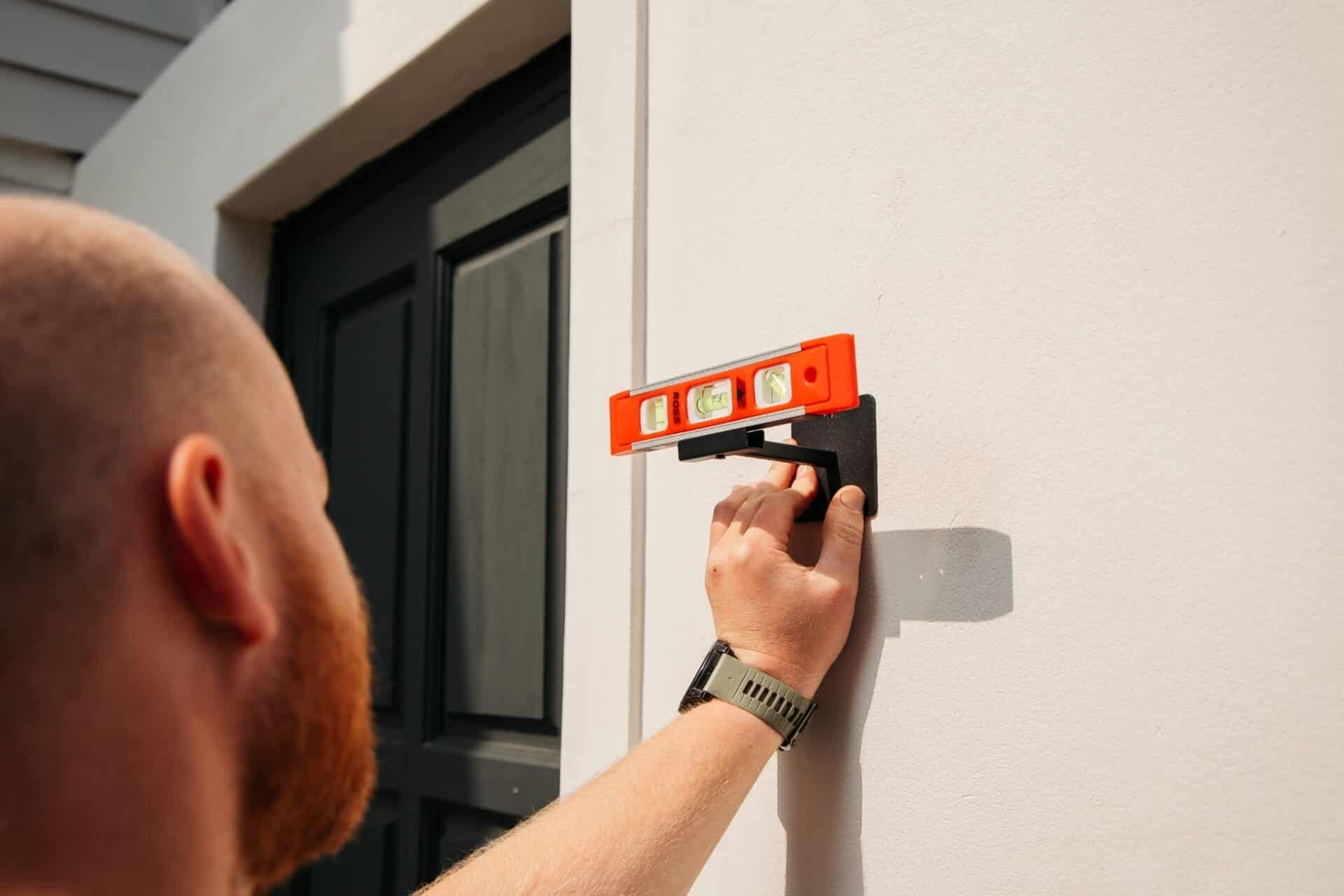 Black Solar Glow Lantern – Weatherproof Outdoor Light Black solar LED lantern mounted on outdoor wall with soft glow