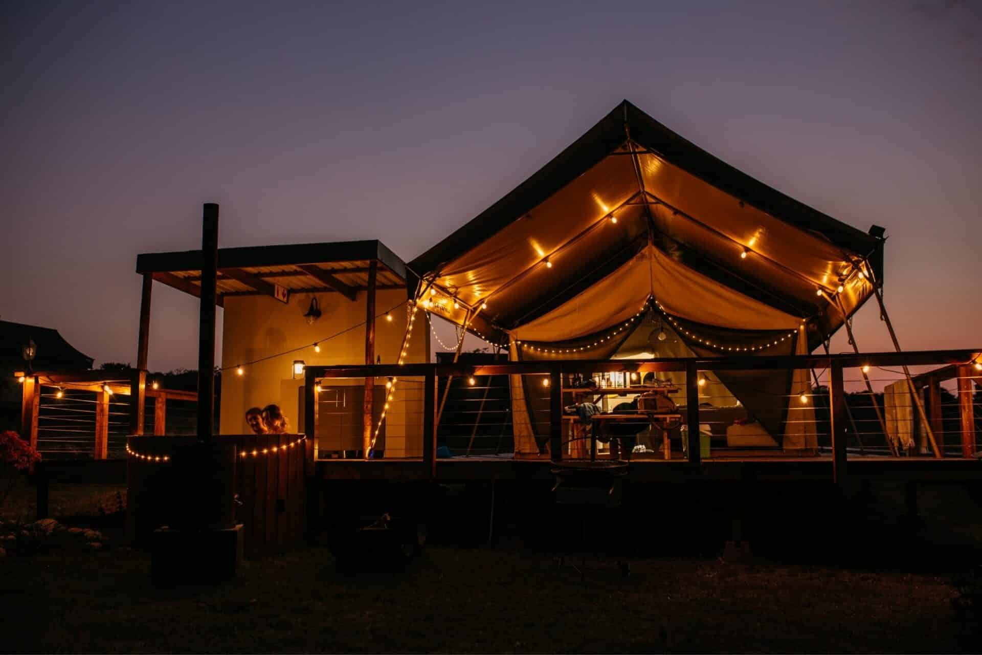 Black Solar Glow Lantern – Weatherproof Outdoor Light Black solar LED lantern mounted on outdoor wall with soft glow