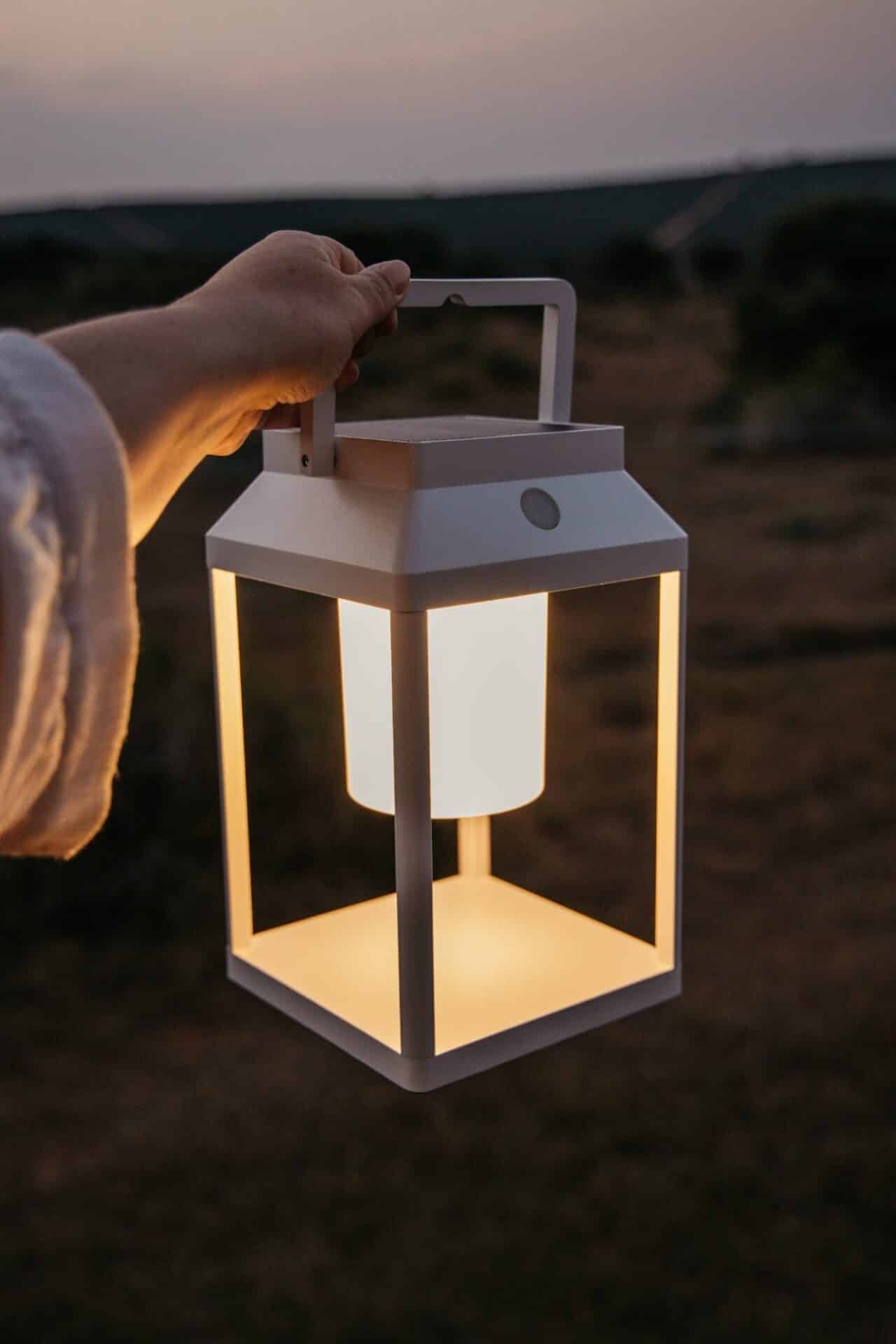 White Solar Glow Lantern – Table & Wall Light Portable white solar LED lantern on table and wall, warm light glow