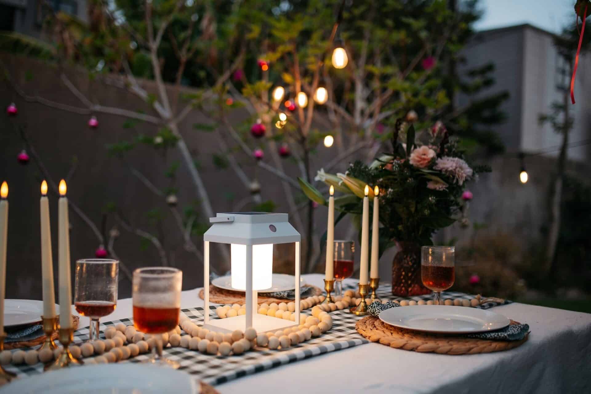 White Solar Glow Lantern – Table & Wall Light Portable white solar LED lantern on table and wall, warm light glow