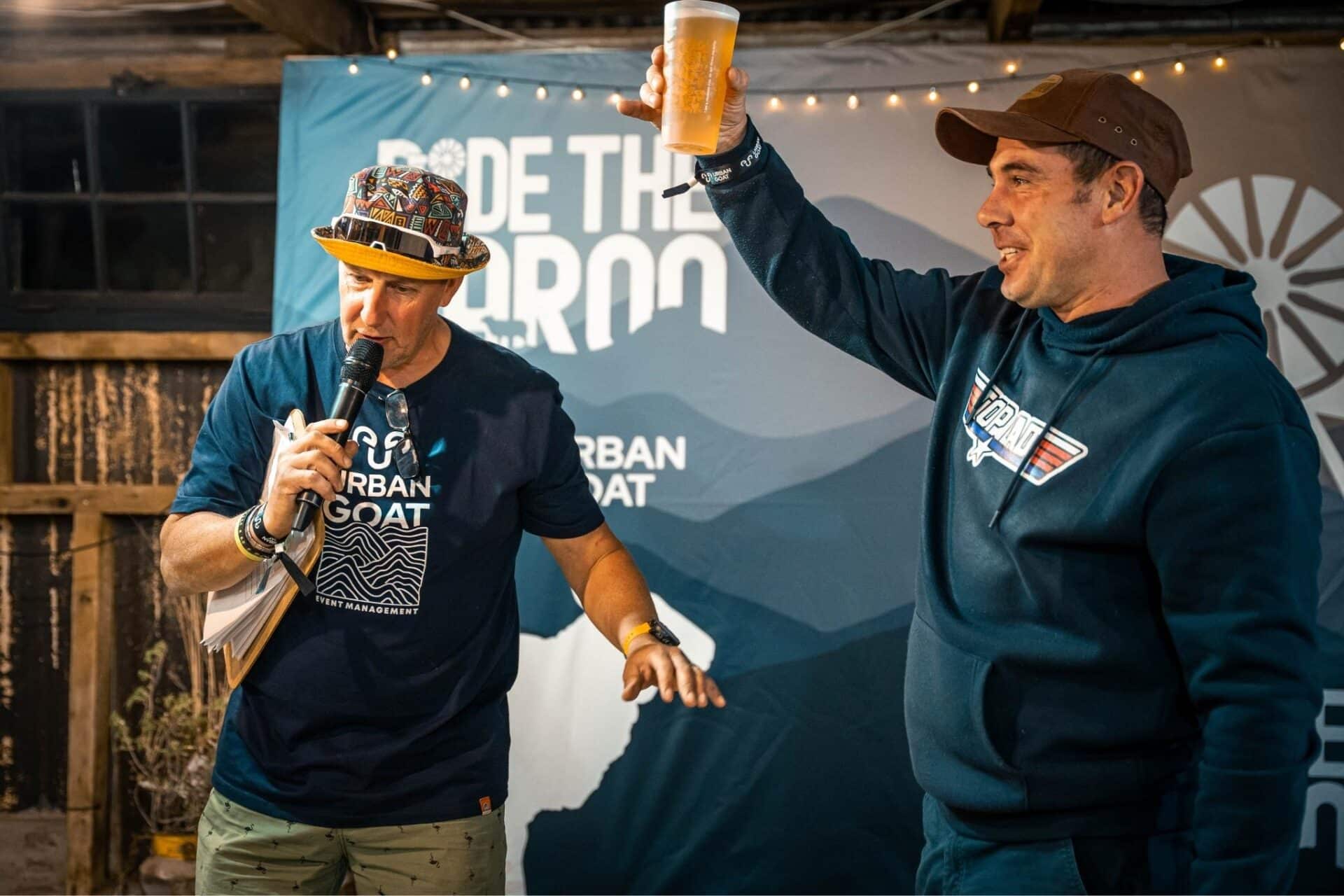 Warm festoon lights above riders sharing dinner at Ride the Karoo