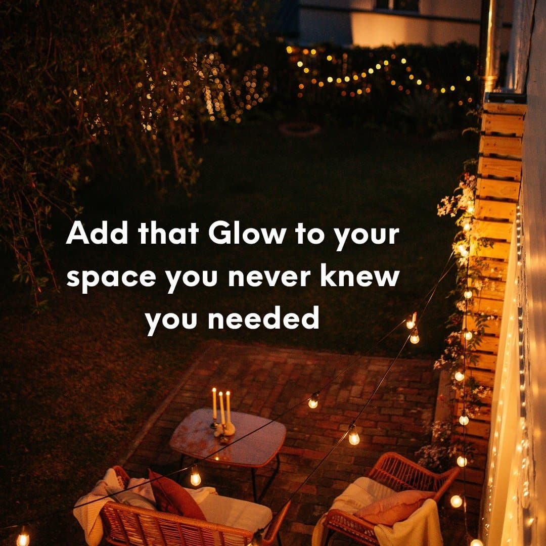 Ivory flameless LED taper candles in holders glowing softly on a dining table.