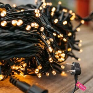 Close up of the 30m heavy duty warm white fairy lights showing the thick dark green cable and dense LED spacing.