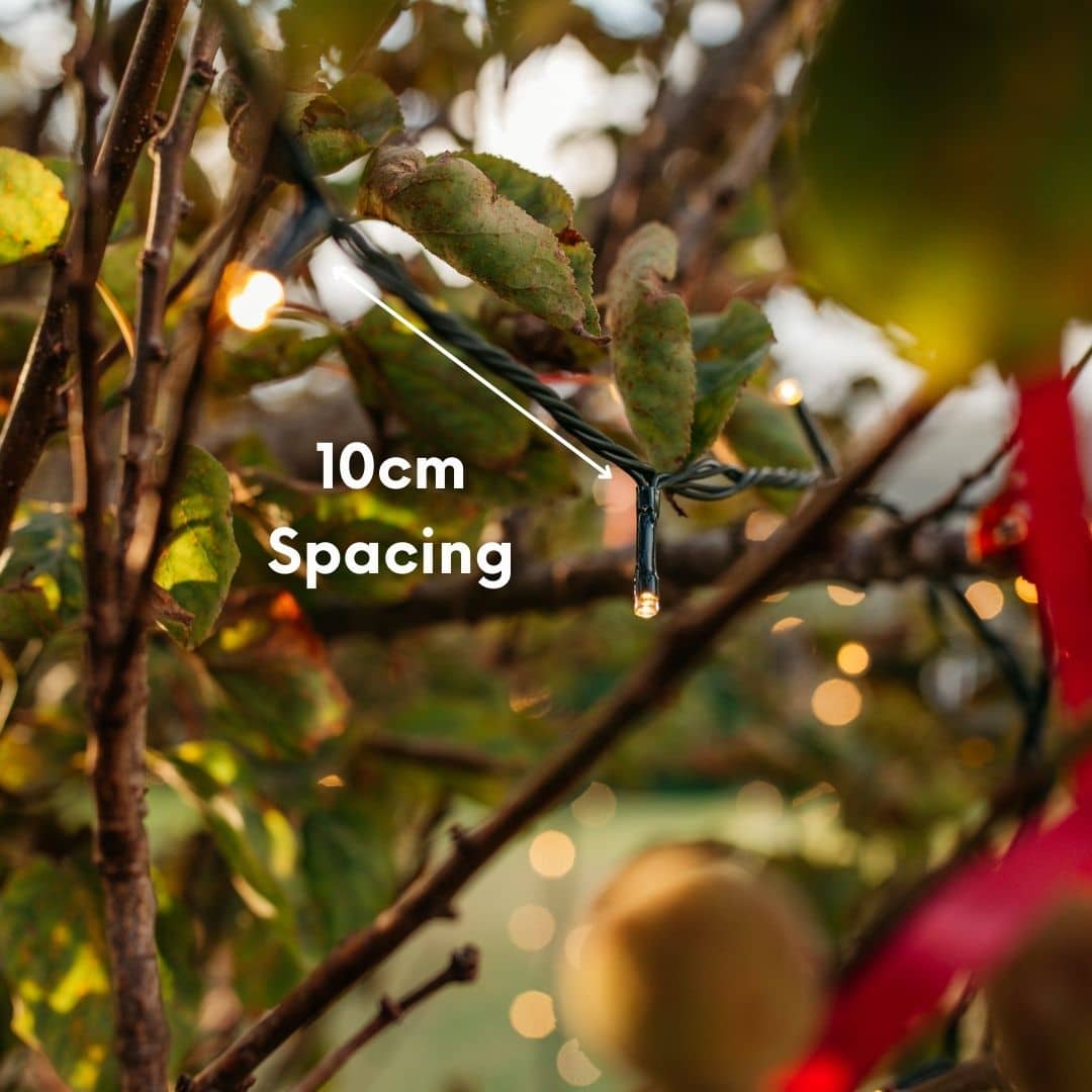 30m warm white heavy duty fairy lights creating a soft outdoor glow in a garden setting.