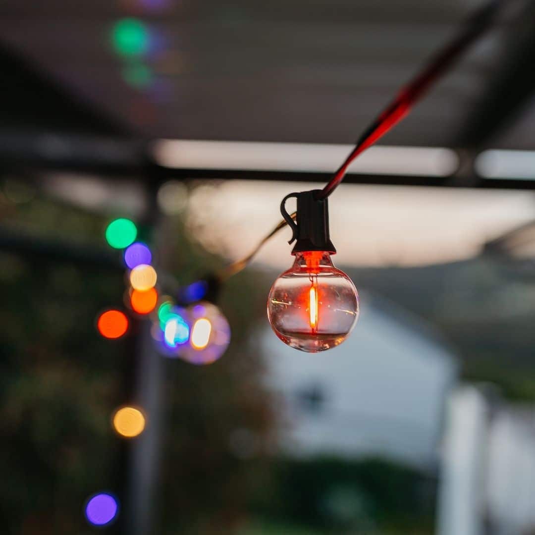 G40 multicolour Christmas bulb close-up on black classic cable