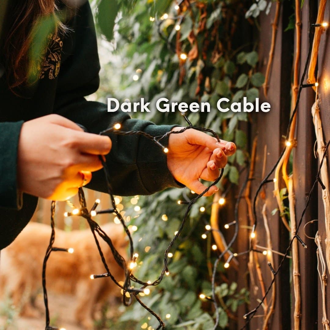 Close up of the 30m heavy duty warm white fairy lights showing the thick dark green cable and dense LED spacing.
