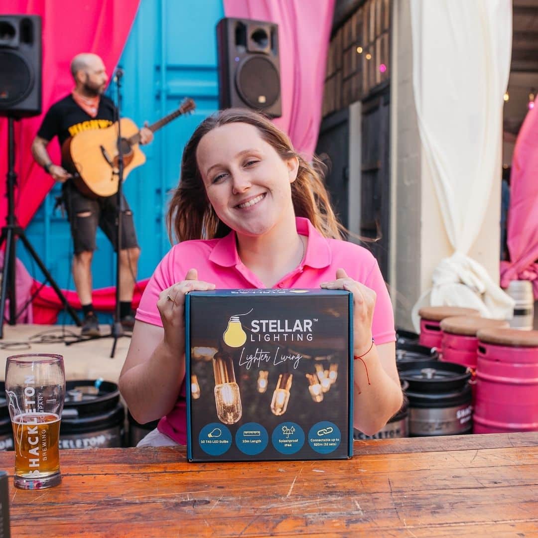 Gold Drop String Lights and Pink Flamingo Bulbs creating a warm, glowing atmosphere at Hazy Cane launch