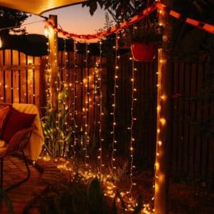 Curtain String Lights - Warm White LED Fairy Lights draped over curtain, creating a cozy atmosphere.
