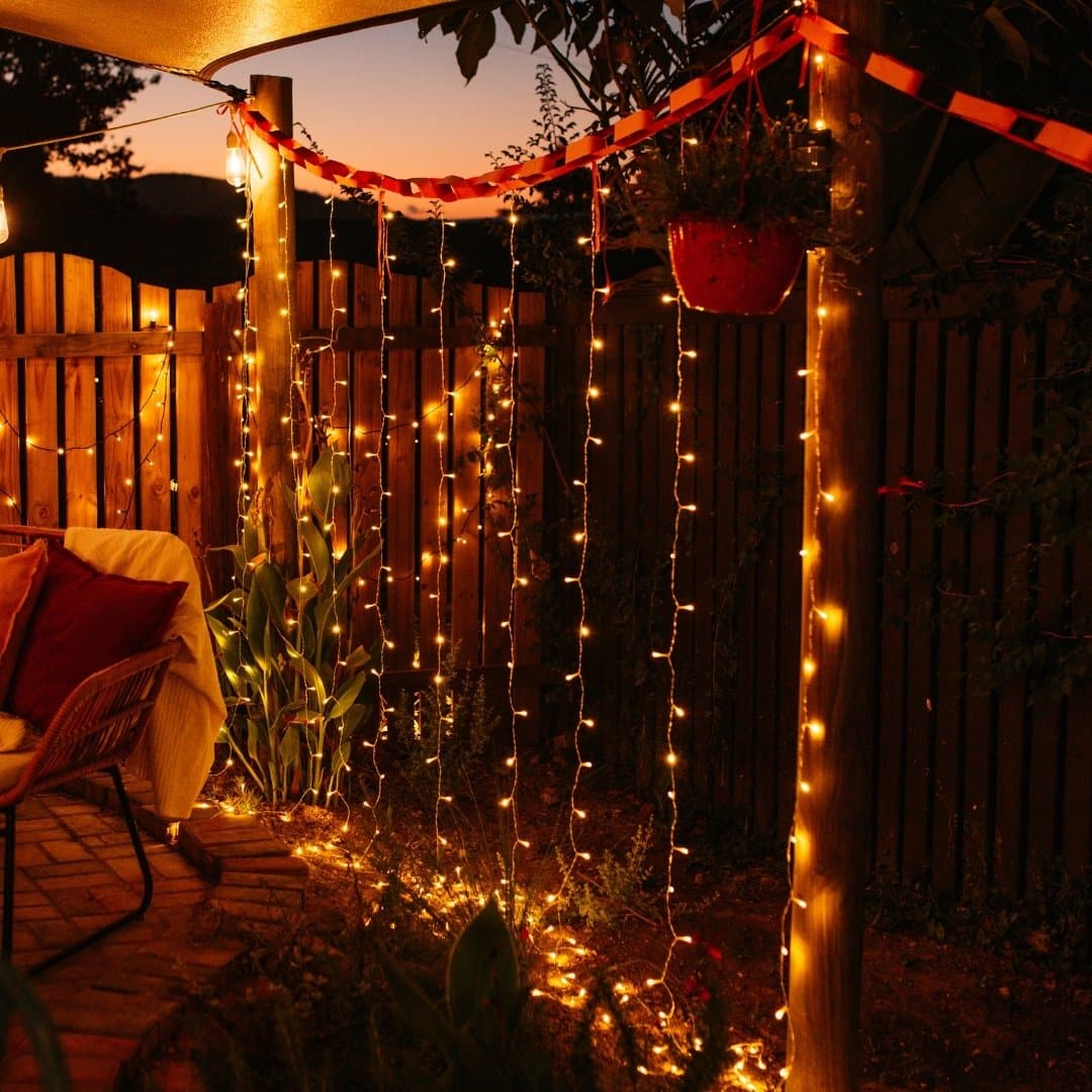Curtain String Lights - Warm White LED Fairy Lights draped over curtain, creating a cozy atmosphere.
