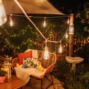 10m white festoon string lights with warm ST64 LED bulbs glowing outdoors