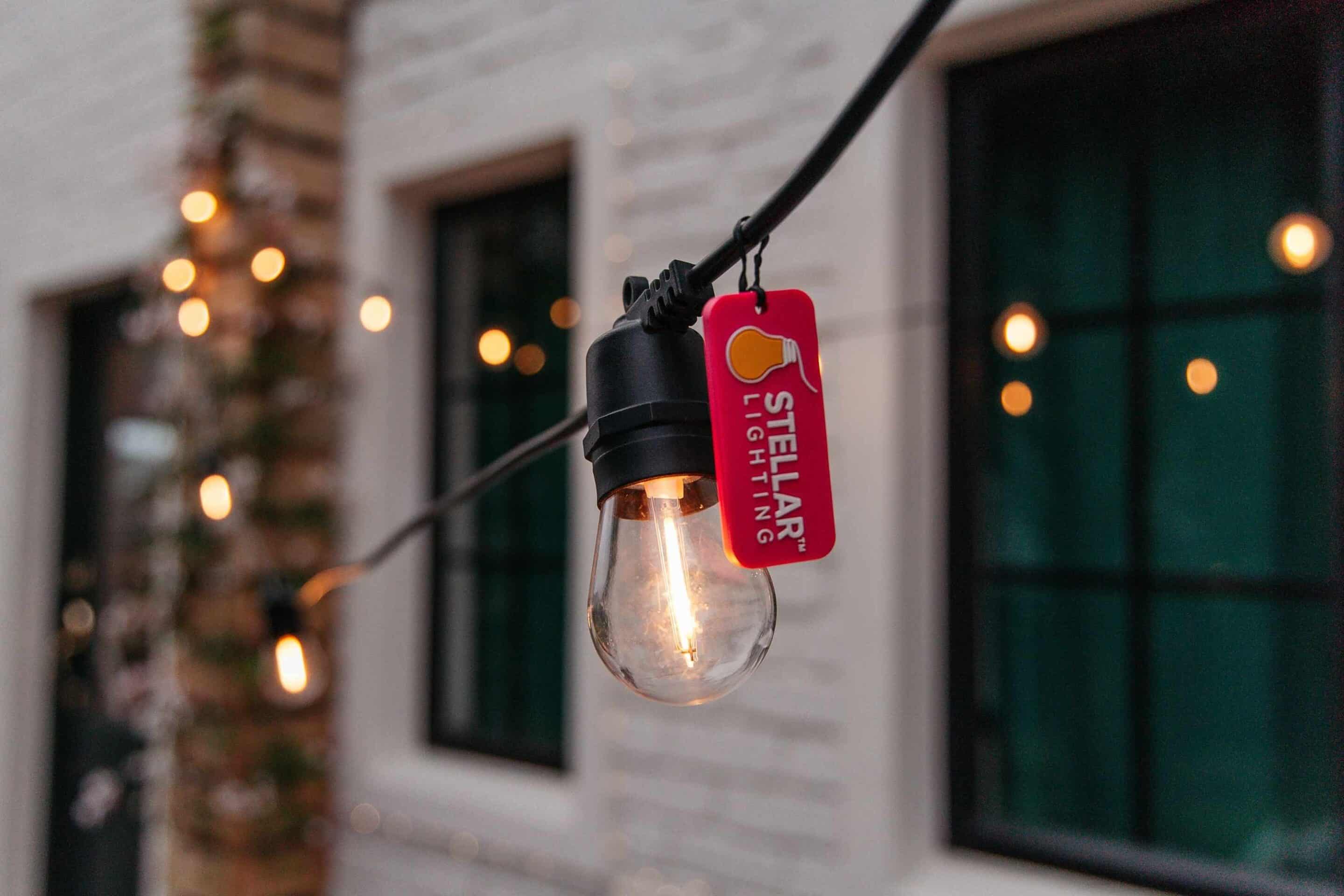 Close-up of solar festoon lights showing warm LED bulbs at night