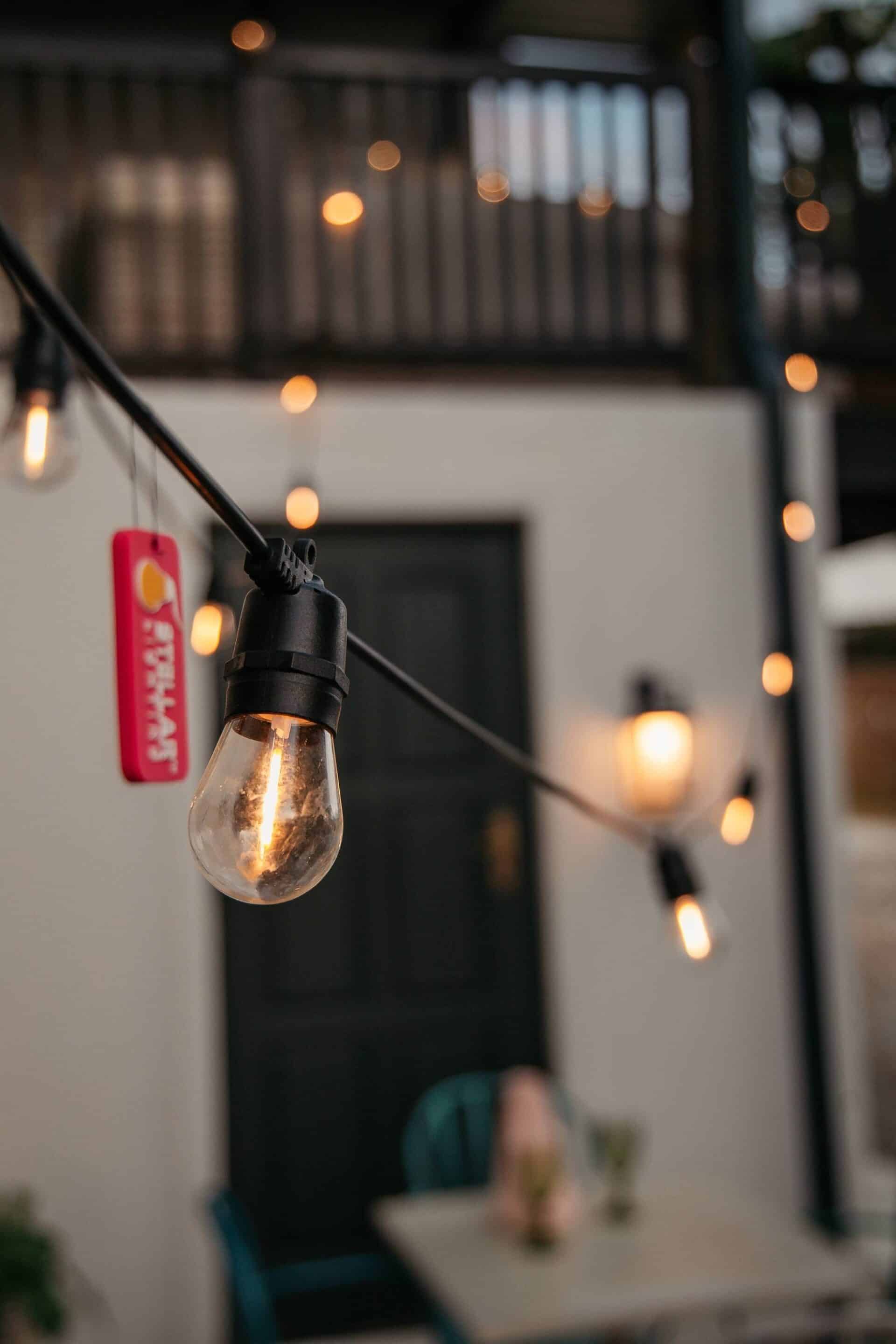 Close-up of solar festoon lights showing warm LED bulbs at night