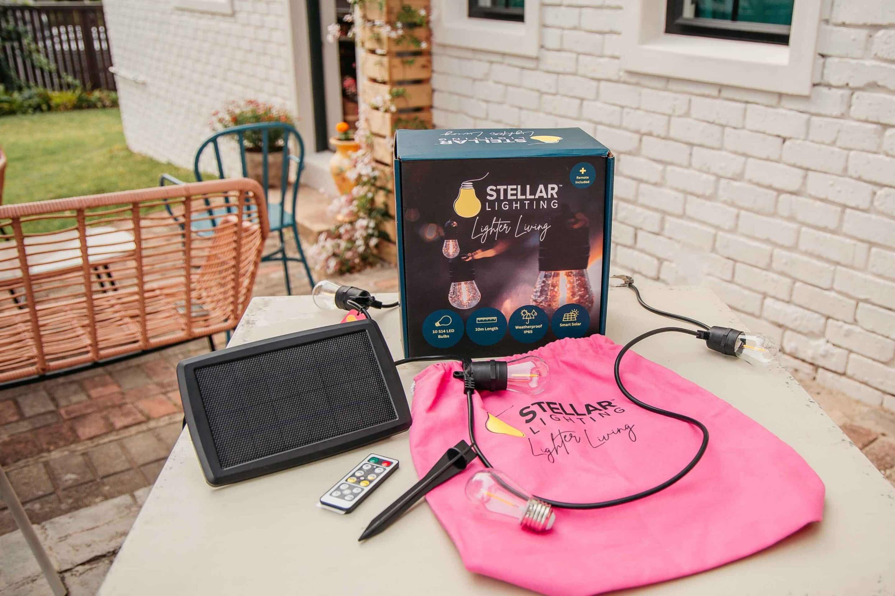 Solar festoon string lights packaging with lights, solar panel, remote and accessories laid out