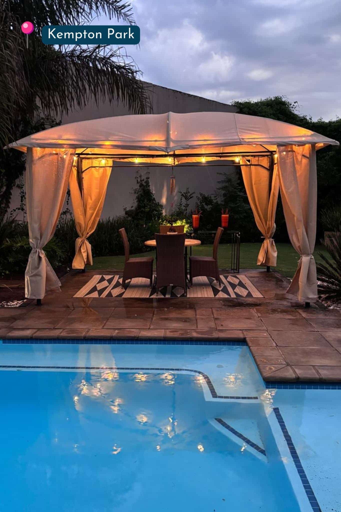 Warm outdoor lights around a wooden pergola next to a swimming pool in Gauteng, South Africa