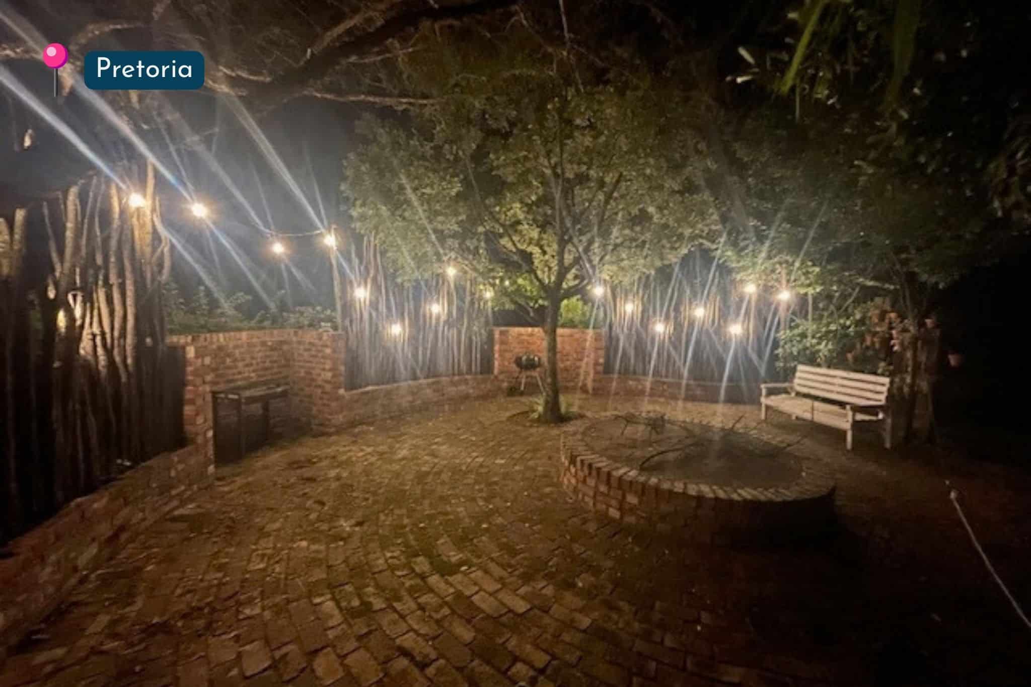 Boma braai area in Pretoria lit with warm drop string lights at night