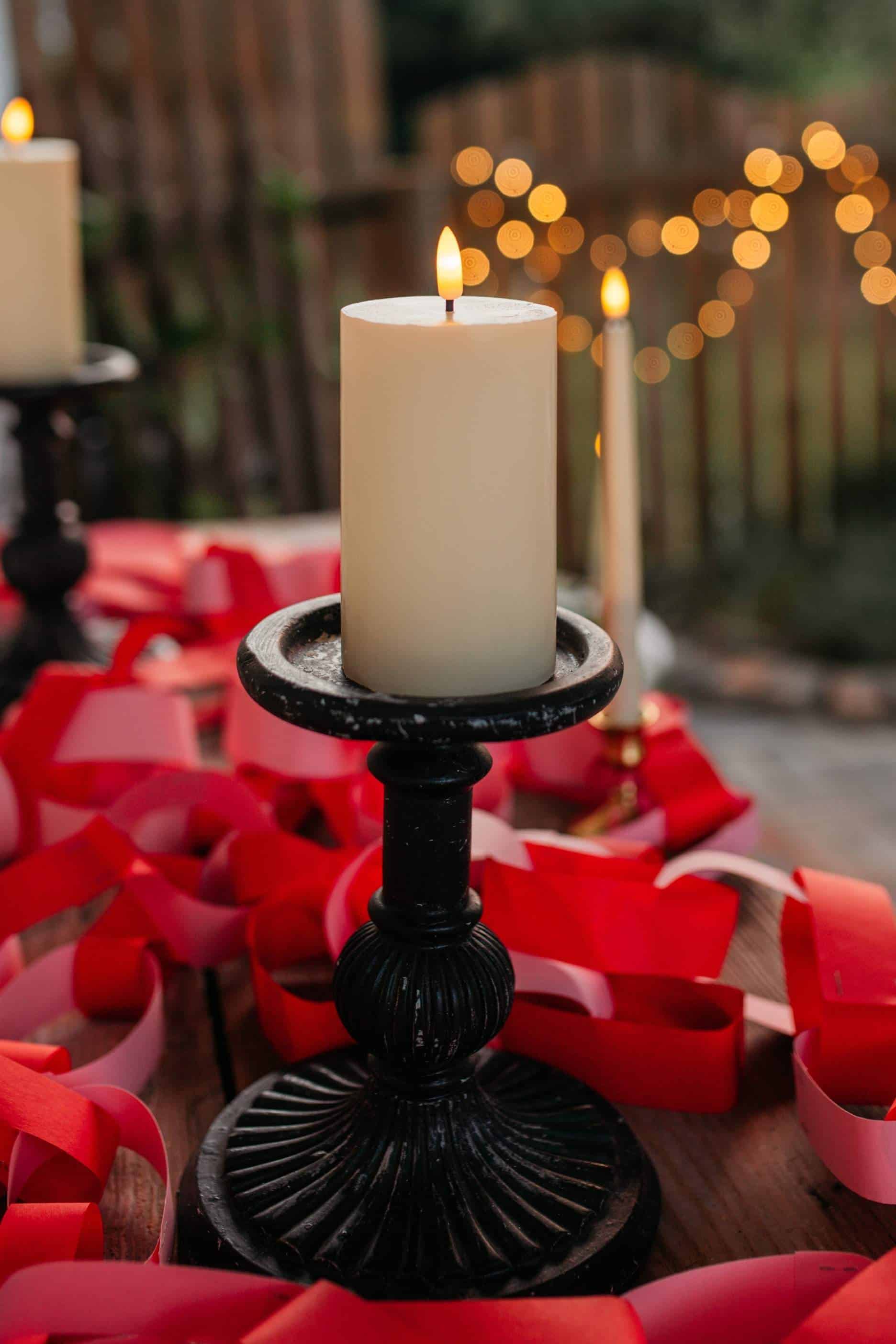 Romantic outdoor seating area lit with candles and soft lighting