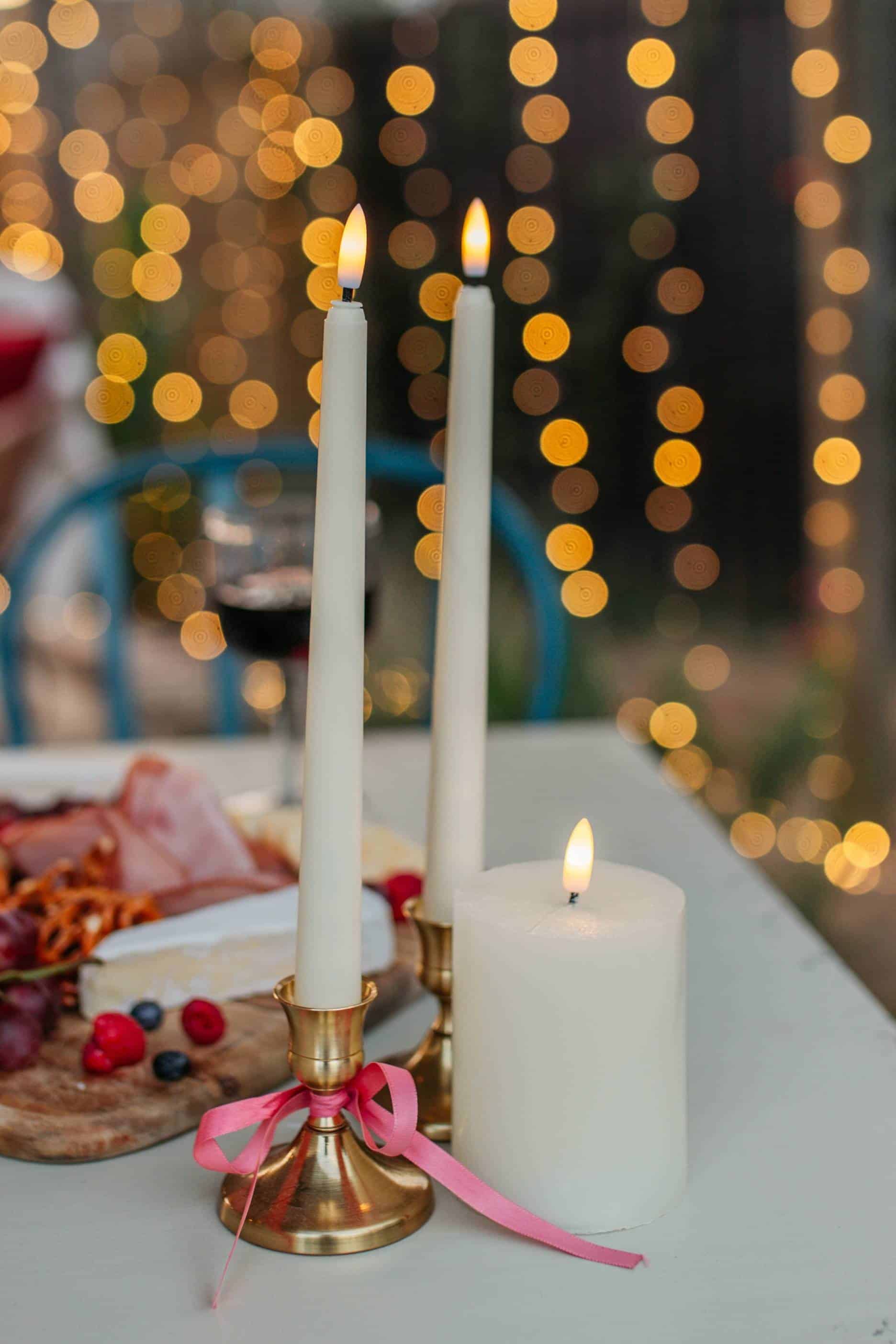 Romantic outdoor seating area lit with candles and soft lighting